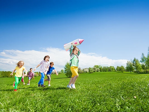 kids playing in the sunshine with a rocket